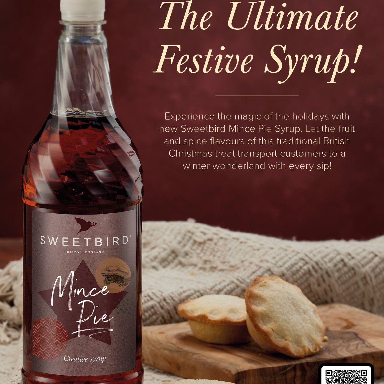 Bottle of Sweetbird Mince Pie Syrup with mince pies on a wooden board against a brown background.
